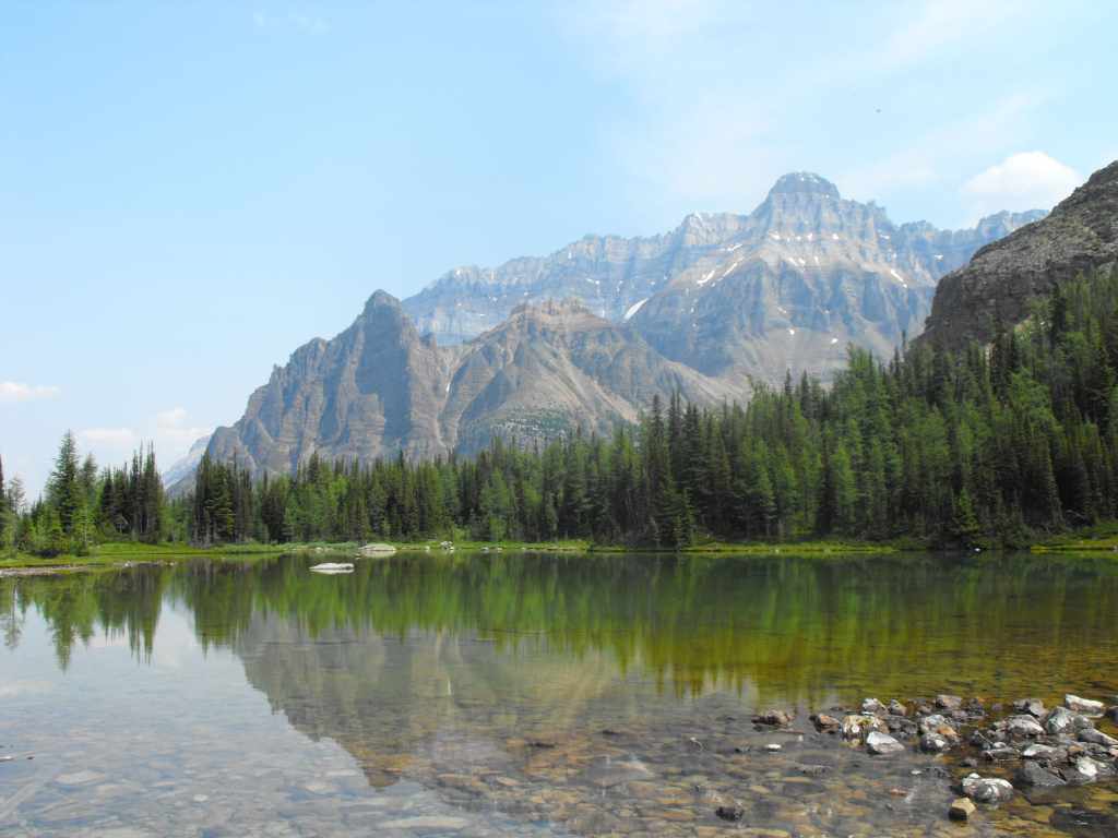 Mountains behind a green lake